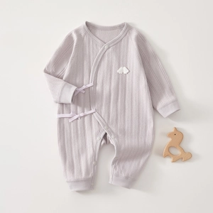 Close-up of light purple ribbed cotton baby romper with cloud applique and side ties