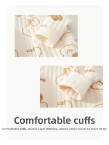 Close-up of baby romper showing cotton rib fabric with cute bear print and ribbed cuffs