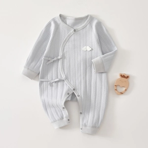 Detail of light blue baby romper made of soft rib knit cotton fabric with wing patch