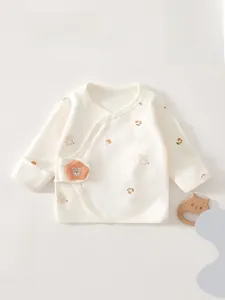 Detailed view of organic cotton newborn wrap shirt featuring cute bear embroidery and snaps