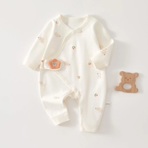 Close-up of 100% cotton baby romper label showing premium soft knit texture and bear print