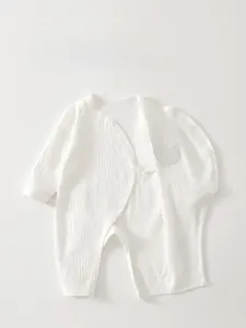 Detail of newborn cotton romper featuring double-layer belly protection and soft rib texture