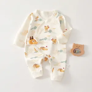 Detail of baby cotton onesie featuring side snap buttons and a 3D dragon decorative patch