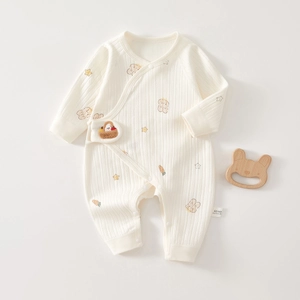 Detail of baby cotton onesie with vertical knit texture and cute cartoon animal prints