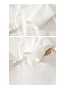 Detail of soft ribbed cuffs and high-quality double stitching on white cotton baby romper