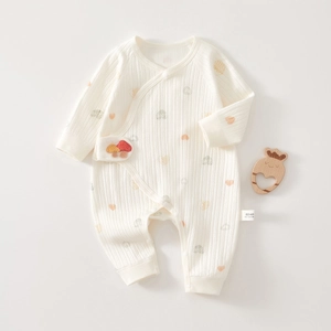Detail of soft 100% cotton newborn jumpsuit with heart prints and mushroom embroidery