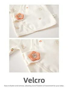 Detail of baby top showing hook-and-loop closure with cute floral and bear prints