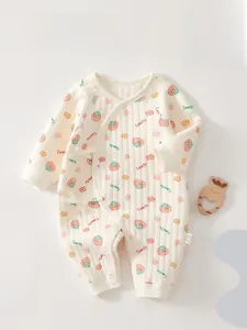 Close-up of quilted newborn baby romper with cute tomato prints and side tie closure