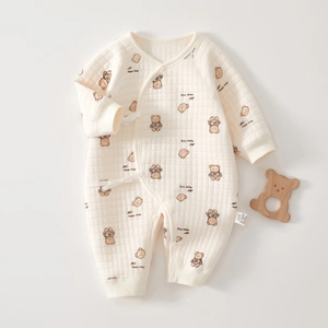 Close-up of quilted cotton baby romper with cute bear prints and tie-up closures