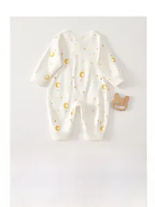 Close-up of pure cotton baby bodysuit with moon and star patterns and wooden teether
