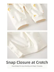 Detail of baby romper featuring white resin snap buttons on the crotch for easy diaper changes