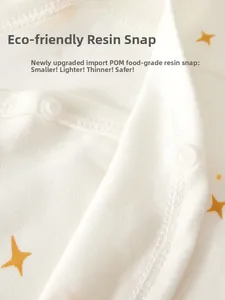 Macro detail of safe POM resin snap buttons on organic cotton newborn baby clothing