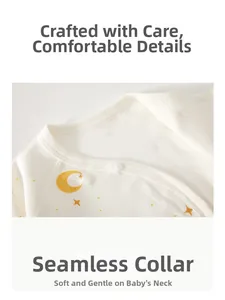 Detail of baby cotton top featuring hemmed neckline with moon and star pattern