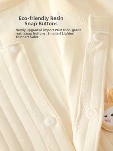 Close-up of pure cotton rib fabric with safe POM resin snaps and rabbit embroidery