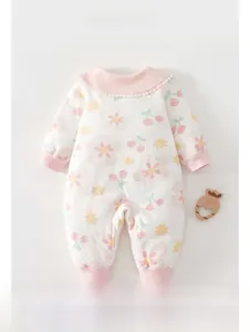 Detail of newborn cotton romper featuring pink floral cherry print and lace collar