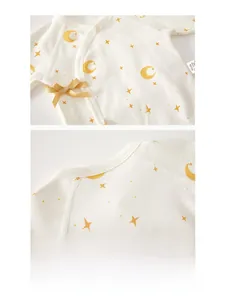 Detailed view of organic cotton baby kimono top with moon and star patterns and side ties