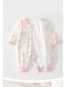 Detail of baby cotton romper featuring floral cherry patterns and lace collar design