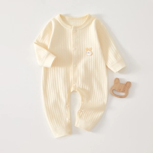 Detail of baby ribbed cotton romper featuring long sleeves and cute bunny embroidery
