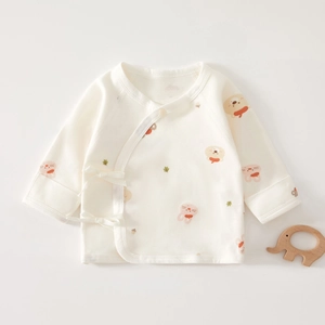 Detail of newborn baby kimono shirt with side ties and cute animal print in soft cotton