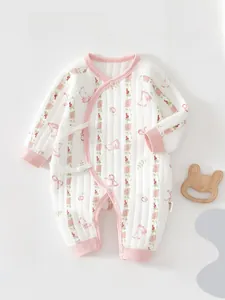 Close-up of baby romper with pink rabbit print, tulip patterns and decorative bows