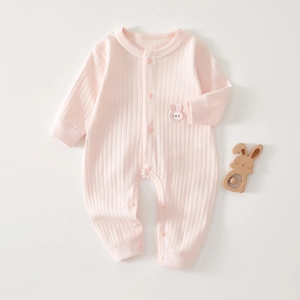 Close-up of pink ribbed cotton baby romper with cute bunny patch and snap buttons