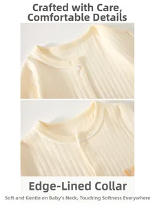 Detail of soft cream ribbed cotton baby romper featuring high-quality edged neckline design
