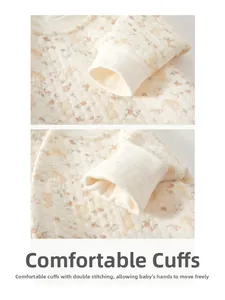 Detailed view of quilted baby romper with rabbit patterns and elastic ribbed cuffs