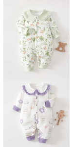 Detail of two floral cotton baby rompers with Peter Pan collars and snap closures