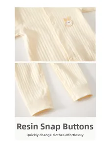 Detail of baby cotton romper with snap buttons and cute rabbit embroidery on rib-knit fabric