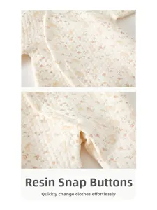 Detail of resin snap buttons on floral quilted baby romper for easy dressing