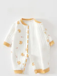 Close-up of quilted cotton baby romper featuring yellow bear prints and snap button closure
