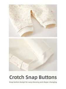 Detail view of snap buttons at the crotch on floral quilted baby romper for easy diapering