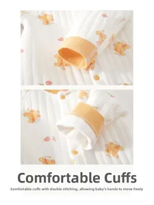 Detail of baby romper yellow ribbed cuff with heart bear pattern and double stitching