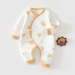 Detail of newborn cotton quilted romper featuring yellow trim and cute angel bear prints