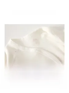 Macro shot of smooth double-needle bound neckline on organic cotton newborn baby shirt