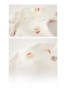 Detail of soft cotton newborn baby top with cute bear print and secure snap buttons
