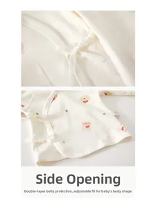 Detail of baby cotton wrap top with side tie closure and cute cartoon animal patterns