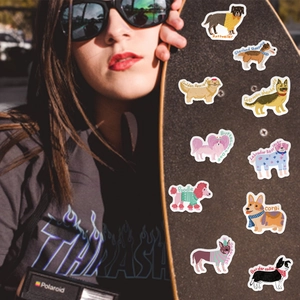 Detail showing waterproof cartoon dog stickers for DIY phone cases and skateboards