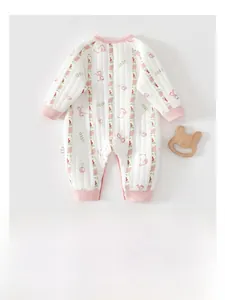 Detail view of cotton quilted baby romper with floral print and pink ribbed edges