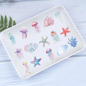 Detailed view of colorful ocean animal stickers including jellyfish and starfish on a tray