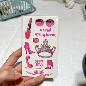 Close-up of pink girl cartoon temporary tattoo stickers with lipstick and crown designs