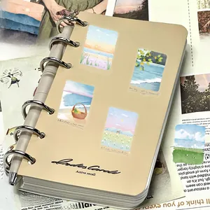 Detail of binder notebook with healing nature landscape stickers and silver metal rings