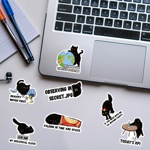 Detail showing various cute black cat stickers with English quotes on a laptop surface