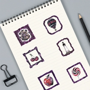 Close-up of decorative gothic PET stickers with vintage frames on a spiral notebook