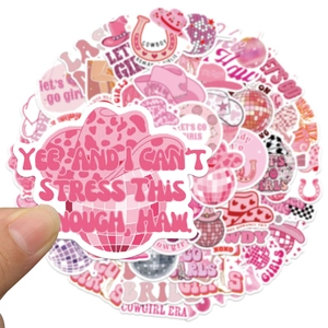 Close-up of pink cowgirl disco sticker being held over a set of waterproof vinyl decals