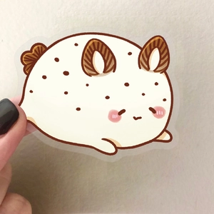 Close-up of a cute sea slug PET sticker held by fingers showing detail and scale