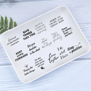 Detail of waterproof PET stickers with black inspirational quotes on a white background