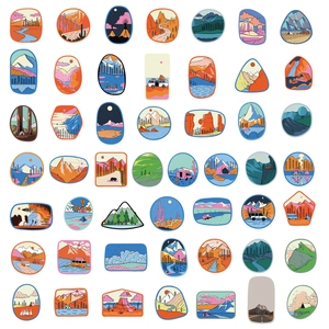 Detailed flat lay of 48 creative outdoor camping stickers with mountain and forest themes