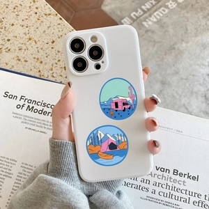 Detailed view of creative outdoor camping stickers on a white iPhone case with scenery motifs