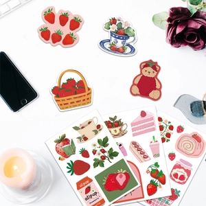 Flatlay of strawberry themed cartoon stickers with dessert patterns for DIY decoration